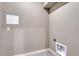 A simple laundry room with gray walls and tile flooring, ready for customization at 91 Greeley Blvd, Palmer Lake, CO 80133