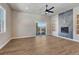 Bright living room featuring a modern fireplace, ceiling fan and large windows at 91 Greeley Blvd, Palmer Lake, CO 80133