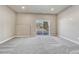 Spacious room with gray carpeting and a large sliding glass door to the outside at 91 Greeley Blvd, Palmer Lake, CO 80133