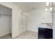 Bright bathroom featuring a walk-in shower, double sinks, and an open closet at 5322 Sandy Ridge Ave, Firestone, CO 80504