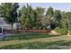 Large backyard with lush green lawn and mature trees, enclosed by a wooden fence at 7154 S Hudson Cir, Centennial, CO 80122