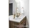 Charming bathroom with double sink vanity, gold fixtures, and modern decor at 7154 S Hudson Cir, Centennial, CO 80122