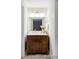 Charming bathroom vanity with wood cabinet, marble countertop, and vintage-style fixtures, adding character at 7154 S Hudson Cir, Centennial, CO 80122