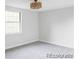 Bright bedroom with gray carpet, white walls, and a modern light fixture at 7154 S Hudson Cir, Centennial, CO 80122