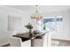 Bright dining room featuring a wood table, white chairs, and large window, perfect for gatherings at 7154 S Hudson Cir, Centennial, CO 80122