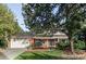Charming two-story home with well-maintained landscaping, mature trees, and a welcoming front entrance at 7154 S Hudson Cir, Centennial, CO 80122