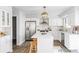 Open-concept kitchen with white cabinetry, stainless steel appliances, an island with seating, and modern fixtures at 7154 S Hudson Cir, Centennial, CO 80122