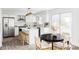 Modern kitchen showcases white cabinets, stainless steel appliances, a center island, and an adjacent dining area at 7154 S Hudson Cir, Centennial, CO 80122