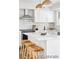 Bright and airy kitchen island with pendant lighting, barstool seating, and modern appliances at 7154 S Hudson Cir, Centennial, CO 80122