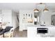 Well-lit open kitchen flows to dining, showcasing an island, stainless appliances, and stairs in view at 7154 S Hudson Cir, Centennial, CO 80122