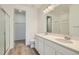 Modern bathroom with double vanity, quartz countertops, and a glass-enclosed shower at 6634 N Malta St, Aurora, CO 80019