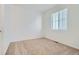 Bright carpeted bedroom features a large window with natural light at 6634 N Malta St, Aurora, CO 80019