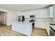 Modern kitchen featuring white cabinets, stainless steel appliances, and a functional center island at 6634 N Malta St, Aurora, CO 80019