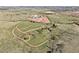 This aerial view captures the sprawling acreage, horse paddocks, and natural landscape of the equestrian property at 1705 Outter Marker Rd, Castle Rock, CO 80108