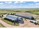 This aerial shot showcases the equestrian facility with barns, paddocks, and scenic views of the surrounding landscape at 1705 Outter Marker Rd, Castle Rock, CO 80108