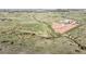 Panoramic aerial view of horse property, riding trails, barns, pasture and mountain views at 1705 Outter Marker Rd, Castle Rock, CO 80108