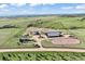 This image shows the extensive horse property, featuring a mix of equestrian facilities, expansive pastures, and rolling terrain at 1705 Outter Marker Rd, Castle Rock, CO 80108