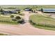 Aerial view of property with gated entrance, barns, and well-maintained pastures at 1705 Outter Marker Rd, Castle Rock, CO 80108