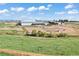Pastoral aerial view of horse property with barns and fenced pastures at 1705 Outter Marker Rd, Castle Rock, CO 80108