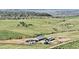 Expansive aerial view of equestrian estate with barns, pastures, and stunning mountain views at 1705 Outter Marker Rd, Castle Rock, CO 80108