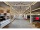 Inside the horse barn, long aisle, featuring multiple stalls at 1705 Outter Marker Rd, Castle Rock, CO 80108