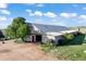 Large barn with an open door and well-maintained grounds on a sunny day at 1705 Outter Marker Rd, Castle Rock, CO 80108