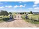 Grand entrance gate leading to a sprawling estate with lush landscapes and scenic views at 1705 Outter Marker Rd, Castle Rock, CO 80108