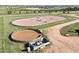Aerial view of horse training rings with jumps and well-maintained grounds at 1705 Outter Marker Rd, Castle Rock, CO 80108