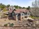 Aerial view of home with stone and gray exterior, landscaping, and outdoor living spaces at 7003 S Irvington Ct, Aurora, CO 80016