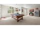 Basement rec room with pool table, ample natural light, and a stainless steel refrigerator at 7003 S Irvington Ct, Aurora, CO 80016