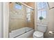 Bathroom with tub and shower combo featuring tile, shower and toilet at 7003 S Irvington Ct, Aurora, CO 80016