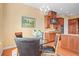 Cozy dining area featuring a modern chandelier, hardwood floors, and kitchen views at 7003 S Irvington Ct, Aurora, CO 80016