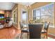 Bright dining area featuring a modern chandelier, hardwood floors, and natural light at 7003 S Irvington Ct, Aurora, CO 80016