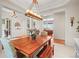 Open dining room featuring a wooden table, hardwood floors, and elegant chandelier lighting at 7003 S Irvington Ct, Aurora, CO 80016