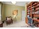 An office featuring a built in bookcase, hardwood desk and accent chair at 7003 S Irvington Ct, Aurora, CO 80016