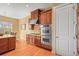 A spacious kitchen featuring wooden cabinets, stainless steel double ovens and a dining area by a window at 7003 S Irvington Ct, Aurora, CO 80016