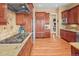 Gourmet kitchen with granite countertops, stainless steel appliances, and hardwood floors at 7003 S Irvington Ct, Aurora, CO 80016
