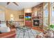 Comfortable living room featuring a stone fireplace, built-in shelves, and hardwood floors at 7003 S Irvington Ct, Aurora, CO 80016
