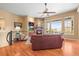 Bright living room featuring a stone fireplace, hardwood floors, and a spacious layout at 7003 S Irvington Ct, Aurora, CO 80016