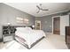 A primary bedroom featuring gray walls, a ceiling fan and an ensuite bathroom at 7003 S Irvington Ct, Aurora, CO 80016