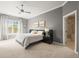 A primary bedroom with gray walls, a ceiling fan, large window, and an ensuite bathroom at 7003 S Irvington Ct, Aurora, CO 80016