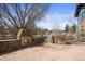 Outdoor patio with stone fireplace and built-in kitchen at 7003 S Irvington Ct, Aurora, CO 80016