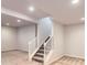 Finished basement with carpet and stairs at 9422 E 58Th Pl, Denver, CO 80238