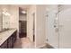Bright bathroom featuring granite counters, a glass shower, and a walk-in closet at 9422 E 58Th Pl, Denver, CO 80238