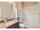 Clean bathroom features granite countertop sink with shower and tub at 9422 E 58Th Pl, Denver, CO 80238