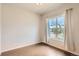 Bedroom featuring hardwood floors, a large window, and neutral paint colors at 9422 E 58Th Pl, Denver, CO 80238