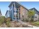 Striking modern home with a well-maintained front yard and unique architectural details at 9422 E 58Th Pl, Denver, CO 80238