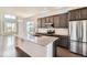 Modern kitchen with stainless steel appliances, granite countertops, and a large center island at 9422 E 58Th Pl, Denver, CO 80238