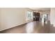 Bright open-concept living area with hardwood floors and a modern kitchen featuring stainless steel appliances at 9422 E 58Th Pl, Denver, CO 80238
