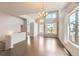 Living room with high ceilings, large windows for natural light, hardwood floors, and modern chandelier at 9422 E 58Th Pl, Denver, CO 80238